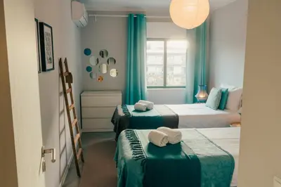 a room with two beds with towels on them at Comfort Zone beach apartment in Quarteira