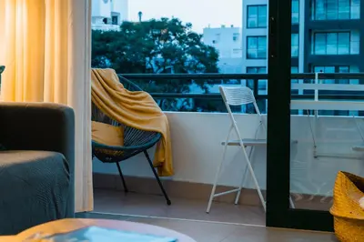 a towel is on a chair on a balcony at Comfort Zone beach apartment in Quarteira