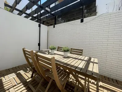 a wooden table with two potted plants on a patio at Vila Flor - Vilamoura in Vilamoura
