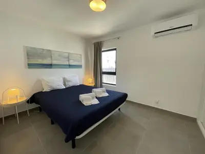 a bedroom with a bed with two towels on it at Vila Flor - Vilamoura in Vilamoura