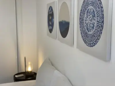 a bedroom with blue and white plates on the wall at Vila Flor - Vilamoura in Vilamoura