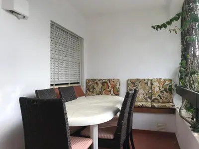 a dining room with a white table and chairs at Comfortable Appartment at Albufeira in Albufeira