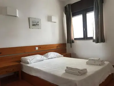 a bedroom with a bed with white sheets and a window at Comfortable Appartment at Albufeira in Albufeira