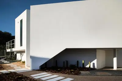 a white building with cacti on the side of it at Boutique Hotel - Casa Esteval in Rocha Amarela