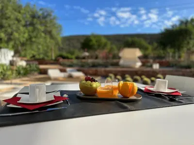 a black tray with a plate of fruit on a table at Boutique Hotel - Casa Esteval in Rocha Amarela