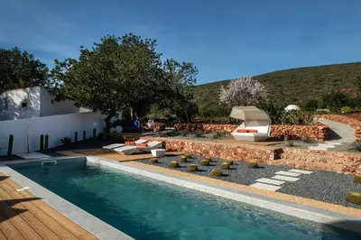 a backyard with a swimming pool and a yard with a hill at Boutique Hotel - Casa Esteval in Rocha Amarela