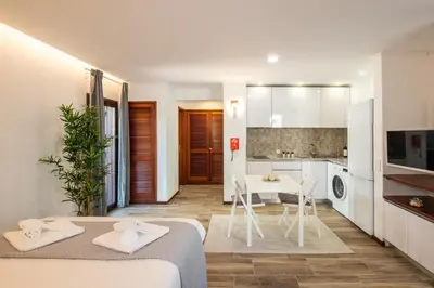 a kitchen with a white refrigerator and a table at #027 T0 Belavista by Home Holidays in Albufeira