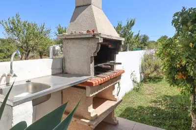 a outdoor kitchen with a sink and a concrete oven at Villa Monte Bixo - Free WIFI . Swimmning Pool - BY BEDZY in Assumadas