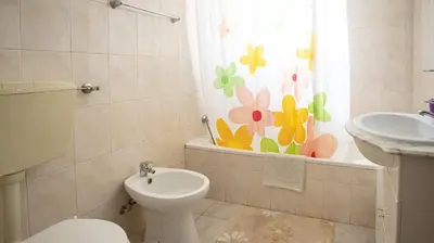 a bathroom with a toilet and a sink and a window at Villa Monte Bixo - Free WIFI . Swimmning Pool - BY BEDZY in Assumadas