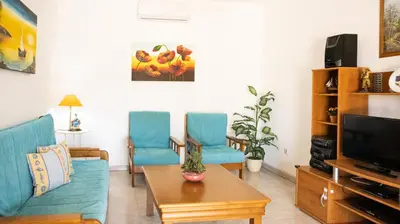 a living room with blue chairs and a tv at Villa Monte Bixo - Free WIFI . Swimmning Pool - BY BEDZY in Assumadas