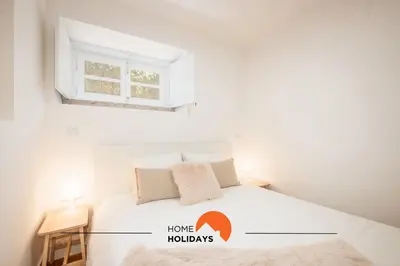 a white bedroom with a bed and a window at #049 Villa Lemon by Home Holidays in Albufeira