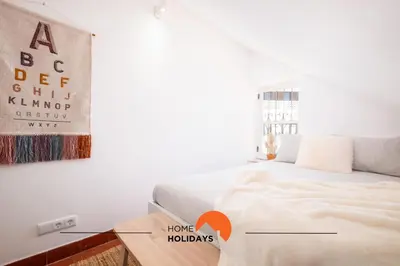 a bedroom with a bed and a painting on the wall at #049 Villa Lemon by Home Holidays in Albufeira