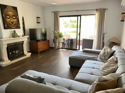 a living room with a couch and a fireplace at Falesia Beach Town house 2 bedroom in Olhos de Água