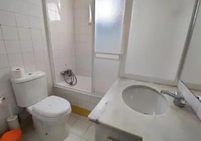 a bathroom with a toilet and a sink and a shower at Cosy studio apartment in Vilamoura in Quarteira