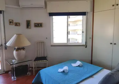 a bedroom with a bed with two slippers on it at Cosy studio apartment in Vilamoura in Quarteira
