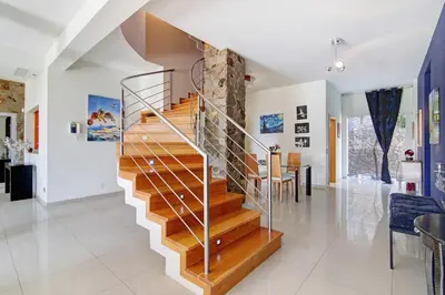 a staircase in a living room with a stone wall at Villa Rosana in Albufeira