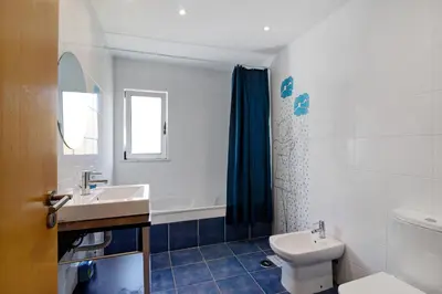 a bathroom with a sink and a toilet at Villa Rosana in Albufeira