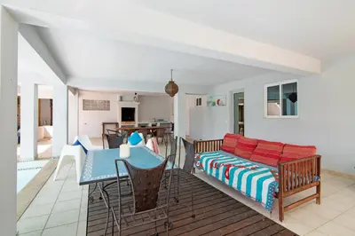 a living room with a table and a couch at Villa Rosana in Albufeira