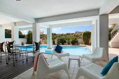 a patio with chairs and a swimming pool at Villa Rosana in Albufeira