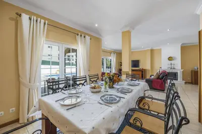 a dining room with a table and some chairs at Villa Carvalho by Villa Plus in Albufeira