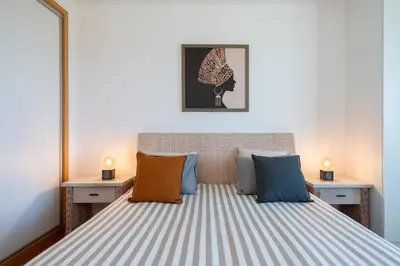 a bedroom with a large bed with colorful pillows at RESIDENCE GOLF CLUB by Intiholidays in Vilamoura