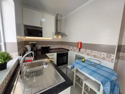 a kitchen with a sink and a counter top at Encosta do Sol Apartamentos in Albufeira