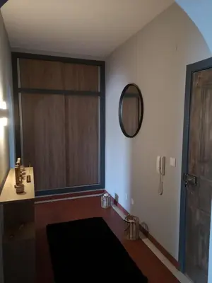 a room with a window and a door with a mirror at Apartamento Recanto do Avô in Albufeira