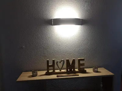 a light on a table with the word love on it at Apartamento Recanto do Avô in Albufeira
