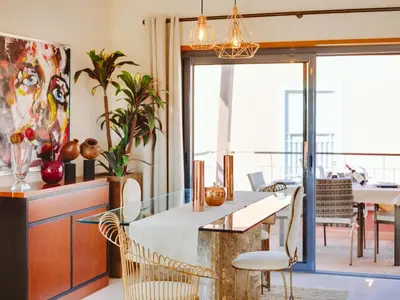 a kitchen with a table and chairs and a dining room at AL - Victoria Gardens in Vilamoura