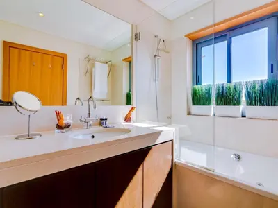 a bathroom with a sink and a large window at AL - Victoria Gardens in Vilamoura
