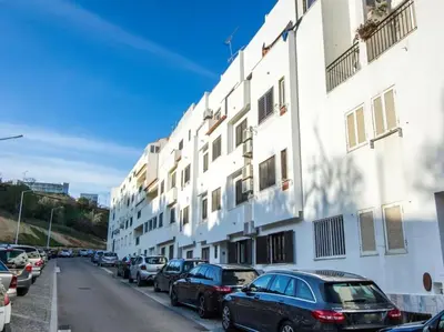 a row of cars parked next to a white building at Old Town Apartment by Stay ici Algarve Holiday Rental in Albufeira