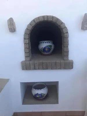 two vases are sitting in a brick oven at CASA DO POÇO in Faro