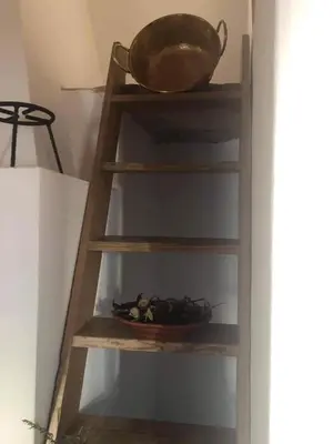 a wooden ladder with a bowl on top of it at CASA DO POÇO in Faro