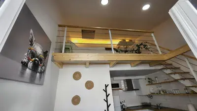 a room with a staircase with a bunk bed at Tiny House Faro in Faro