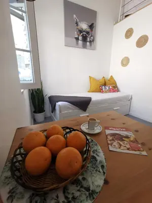 a bowl of oranges on a table in a room at Tiny House Faro in Faro