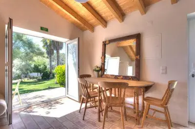 a bedroom with a bed with pillows and a window at Casa De Mondo in Boliqueime