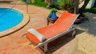 a picture of a wooden table with wicker chairs at Casa De Mondo in Boliqueime