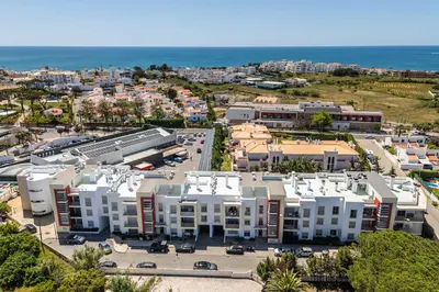 an aerial view of a city with buildings and the ocean at T2 Eucalipto 2A by Algarneto in Olhos de Água