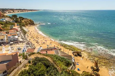 an aerial view of a beach with people on it at T2 Eucalipto 2A by Algarneto in Olhos de Água