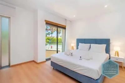 a bedroom with a large bed and a large window at Patroves Sea View - Dream Lodging in Albufeira