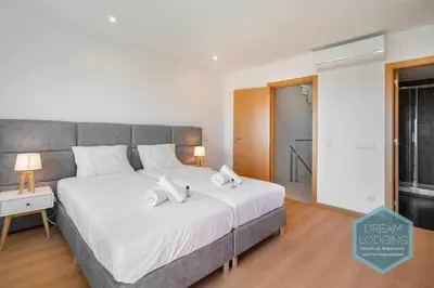 a bedroom with a large bed with two towels on it at Patroves Sea View - Dream Lodging in Albufeira