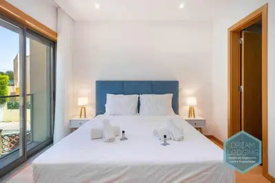 a bedroom with a large white bed and a large window at Patroves Sea View - Dream Lodging in Albufeira