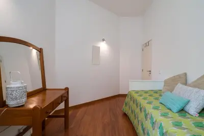 a bedroom with a bed and a mirror and a table at Villa Macuti by SAPvillas in Vilamoura