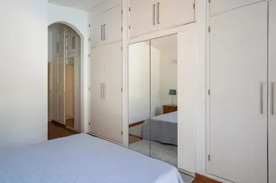 a bedroom with white cabinets and a bed at Villa Macuti by SAPvillas in Vilamoura