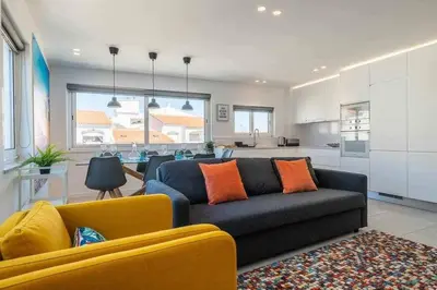 a living room with a couch and a kitchen at Central Town 2-Bedroom Apartment Albufeira in Albufeira