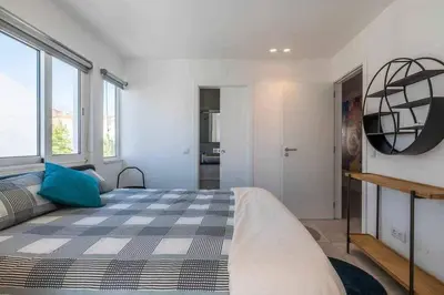 a bedroom with a large bed and a large window at Central Town 2-Bedroom Apartment Albufeira in Albufeira