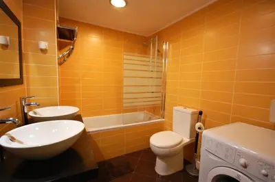 a bathroom with a toilet and a sink and a tub at T0 Estudio Leziria - Swimming pool in Vilamoura