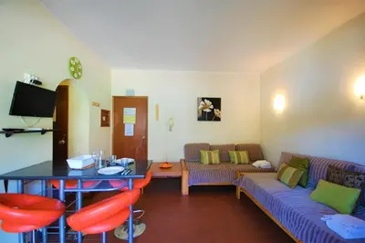 a living room with a couch and a table at T0 Estudio Leziria - Swimming pool in Vilamoura