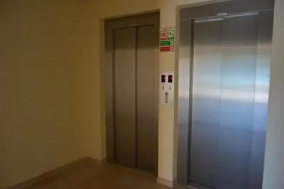 an elevator in a building with a metal door at Albufeira Marina Views in Albufeira
