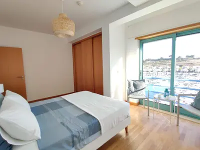 a bedroom with a bed and a window with a view at Albufeira Marina Views in Albufeira